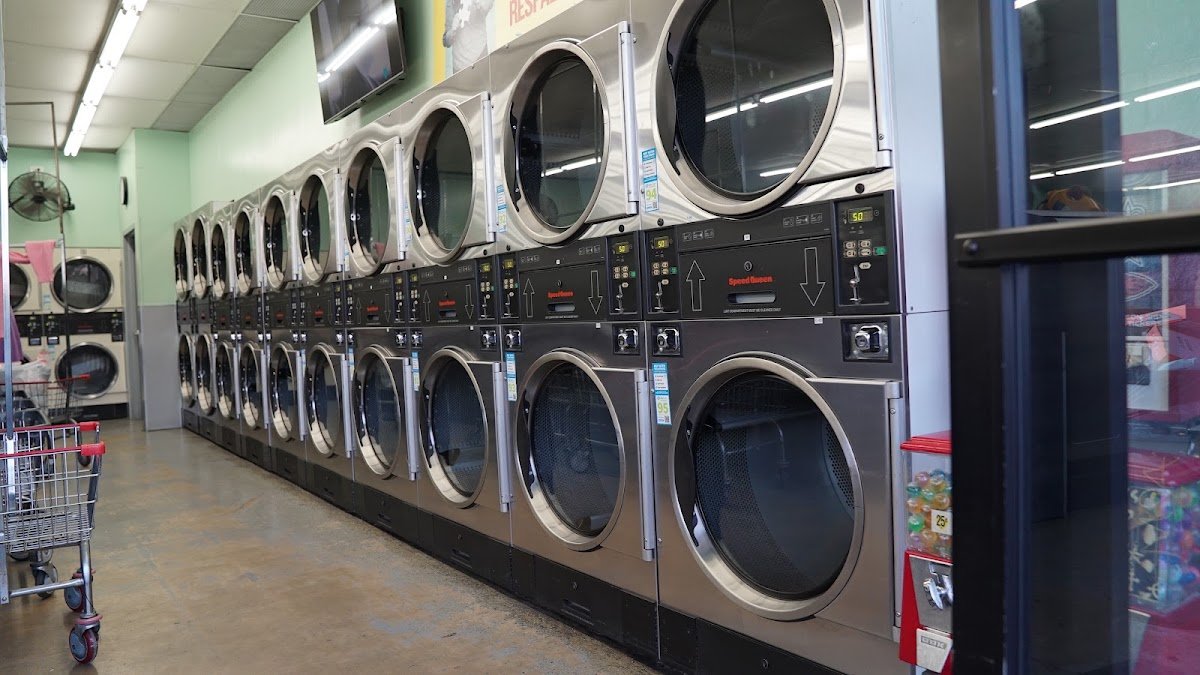 A long wall of stainless steel stacked dryers