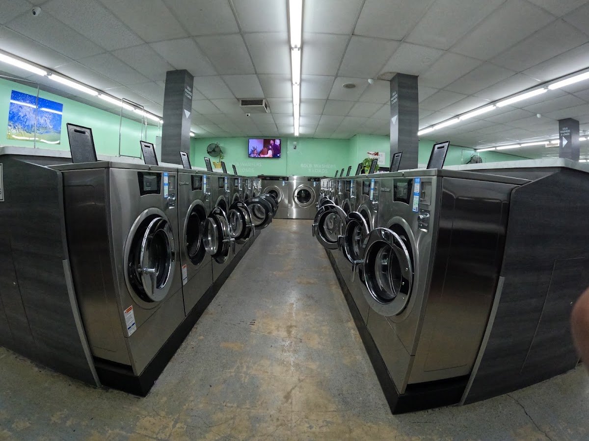 An aisle lined with large front-loading washers